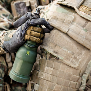glass hand grenade energy drink in held by a soldier in battle